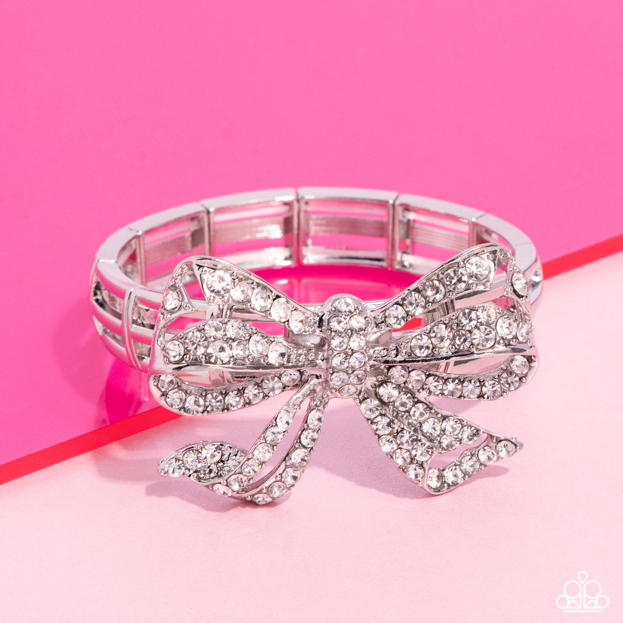 IT'S ALL A-BOW-TO ME - WHITE RHINESTONE SILVER BOW STRETCH BRACELET - PAPARAZZI - LIFE OF THE PARTY MAY 2024