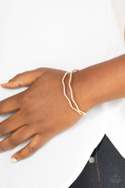 DELICATE DAZZLE - GOLD WHITE RHINESTONE STRETCHY CUFF BRACELET - PAPARAZZI