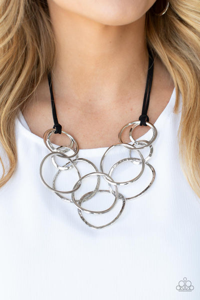 SPIRALING OUT OF COUTURE - SILVER CIRCLE BLACK LEATHER CORD NECKLACE - PAPARAZZI