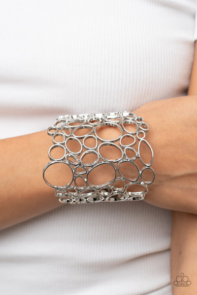 ALL TURNED AROUND - SILVER OVAL CUFF BRACELET - PAPARAZZI
