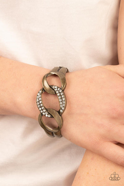 BOMBSHELL SQUAD - BRASS LINK WHITE RHINESTONE HINGED BRACELET - PAPARAZZI