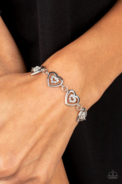 CATCHING FEELINGS - WHITE RHINESTONE SILVER HEART BRACELET - PAPARAZZI